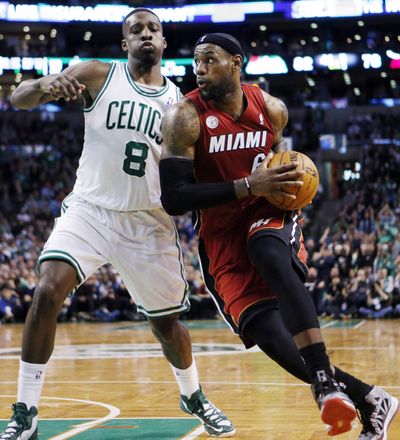 Miami’s LeBron James drives past Boston’s Jeff Green for two of his 37 points as Heat upped their winning streak to 23 on Monday. (Associated Press)