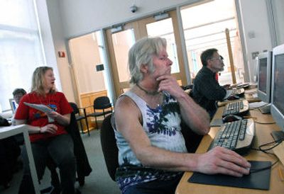 
Byron Potter, center, and David Rummel, right, learn about e-mail from librarian Dana Dalrymple, left, at the downtown Spokane Public Library.
 (Dan Pelle / The Spokesman-Review)