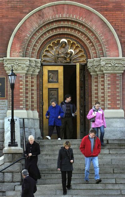 
Participants in noon Mass leave Our Lady of Lourdes Cathedral in Spokane on Thursday. A $48 million settlement announced Thursday would end the Spokane Diocese's bankruptcy. 
 (Holly Pickett / The Spokesman-Review)