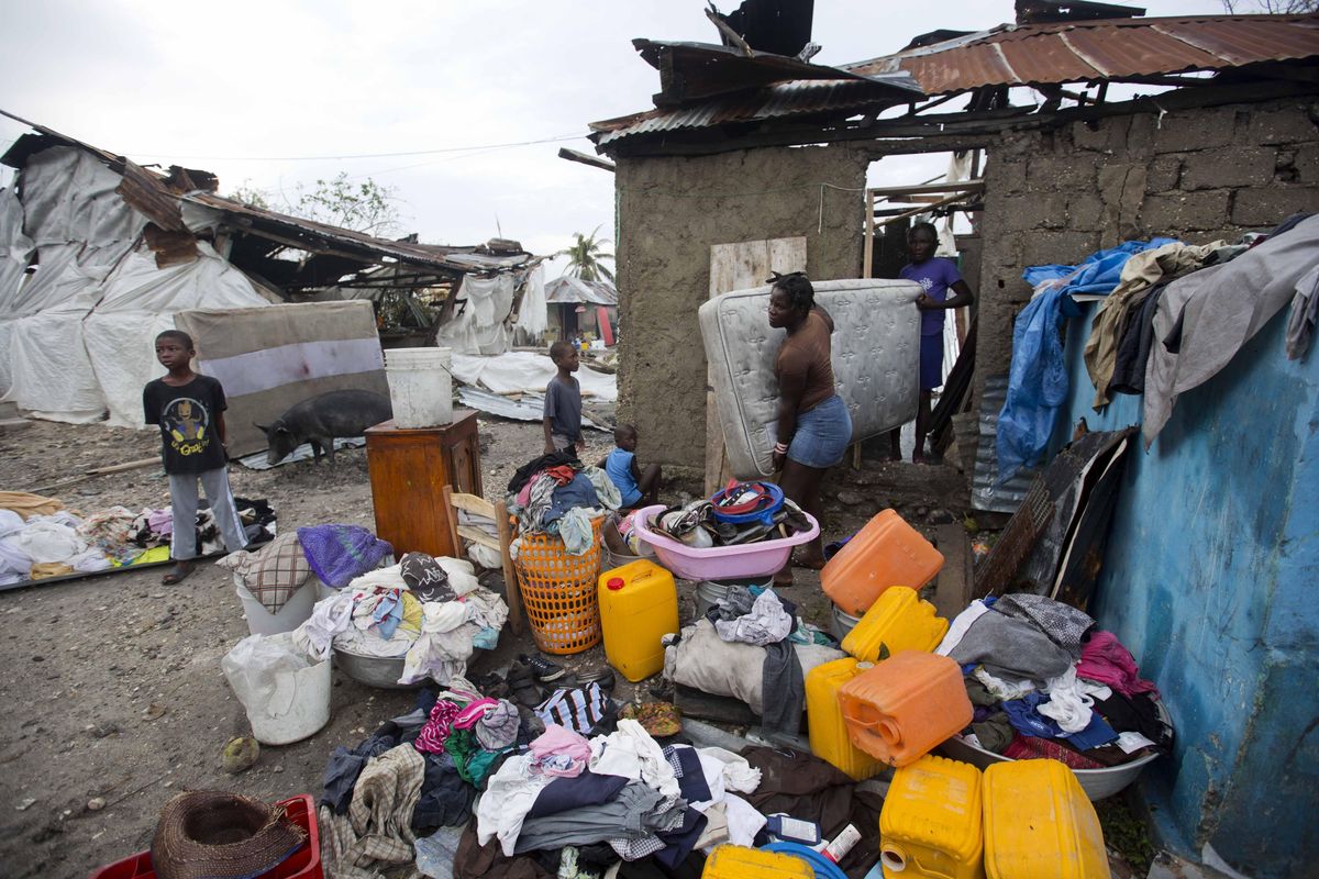 Personal items are set out to dry as homeowners cull through the debris of their homes destroyed by Hurricane Matthew in Les Cayes, Haiti, Thursday, Oct. 6, 2016. Two days after the storm rampaged across the country’s remote southwestern peninsula, authorities and aid workers still lack a clear picture of what they fear is the country’s biggest disaster in years. (Dieu Nalio Chery / Associated Press)