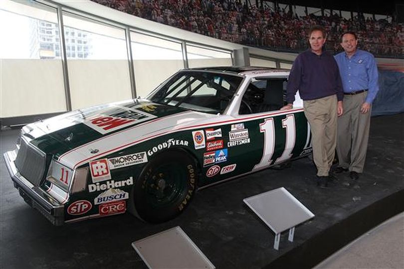 (Left to right) Three-time NASCAR Sprint Cup Series champion Darrell Waltrip presents his No. 11 Mountain Dew Buick, which won the 1981 and 1982 titles, to NASCAR Hall of Fame Executive Director Winston Kelley Monday in Charlotte at the Hall of Fame. (Photo courtesy of Streeter Lecka/Getty Images)