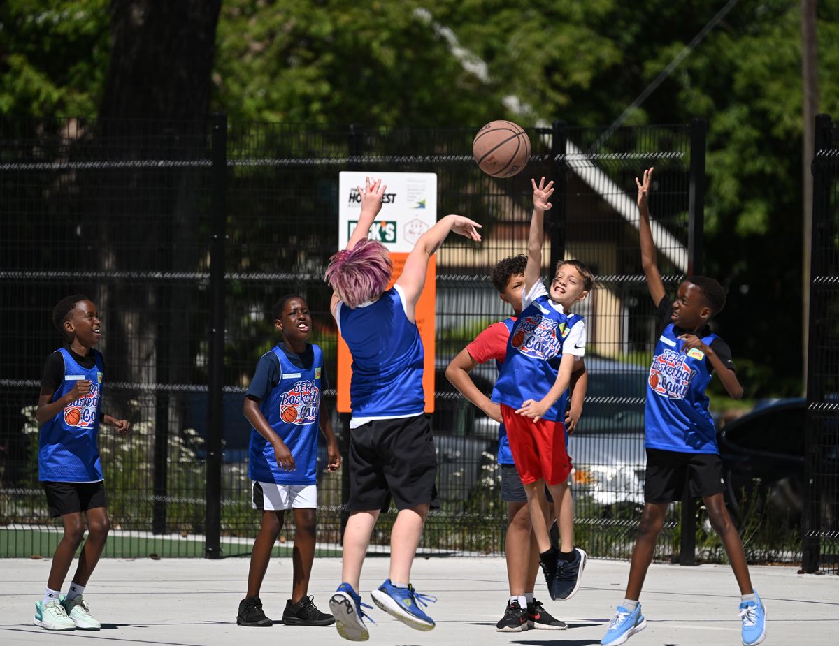 Kids at the Spokane Eastside Reunion Basketball Camp scrimmage Thursday on the new court at Underhill Park, a community park in the East Central neighborhood of Spokane. The renovation included a new basketball court, pickleball courts, fencing and other upgrades. (Jesse Tinsley/THE SPOKESMAN-REVIEW)