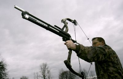 An archer draws a compound bow equipped with an Airow Gun, a bow-blowgun hybrid that comes in two versions: One launches the .689 caliber paintballs that gamers fire by the millions each year. The other shoots .22-caliber pellets.Eugene Register-Guard (Eugene Register-Guard / The Spokesman-Review)