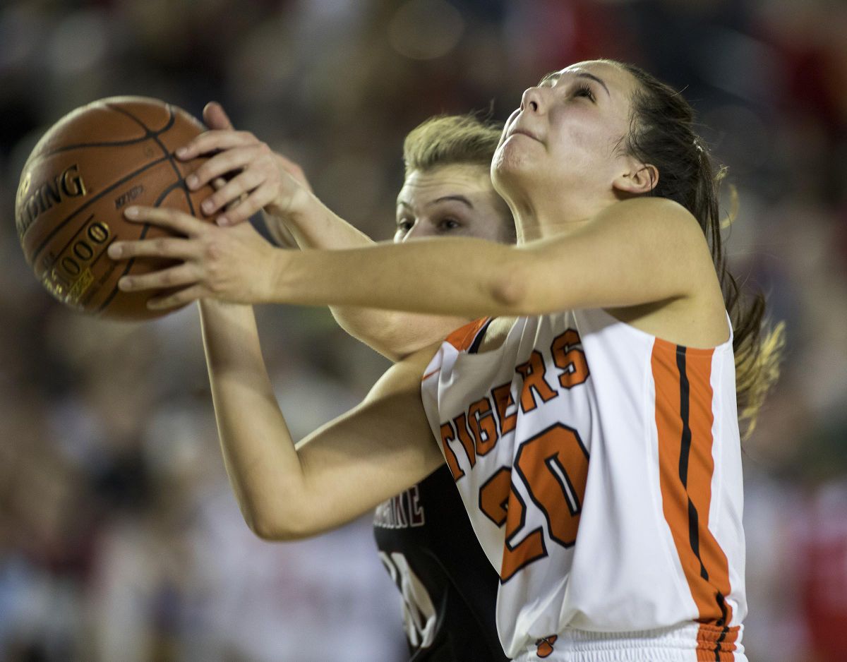 Lewis and Clark’s Dominique Arquette, right, gets fouled by Eastlake’s Callie Lind as she drives to the hoop in the State 4A championship game Saturday  in Tacoma. Eastlake won 53-47. (Patrick Hagerty / Patrick Hagerty)