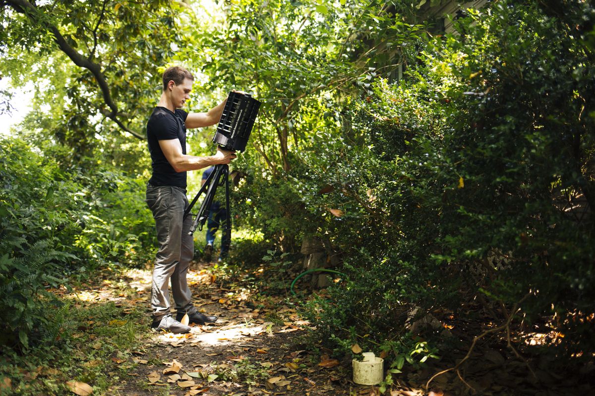 In this photo provided by Microsoft, Microsoft researcher Ethan Jackson sets up a trap for mosquitoes in Harris County, Texas, in 2016. A new high-tech version trap is promising to catch the bloodsuckers while letting friendlier insects escape, and even record the exact weather conditions when different species emerge to bite. (AP)