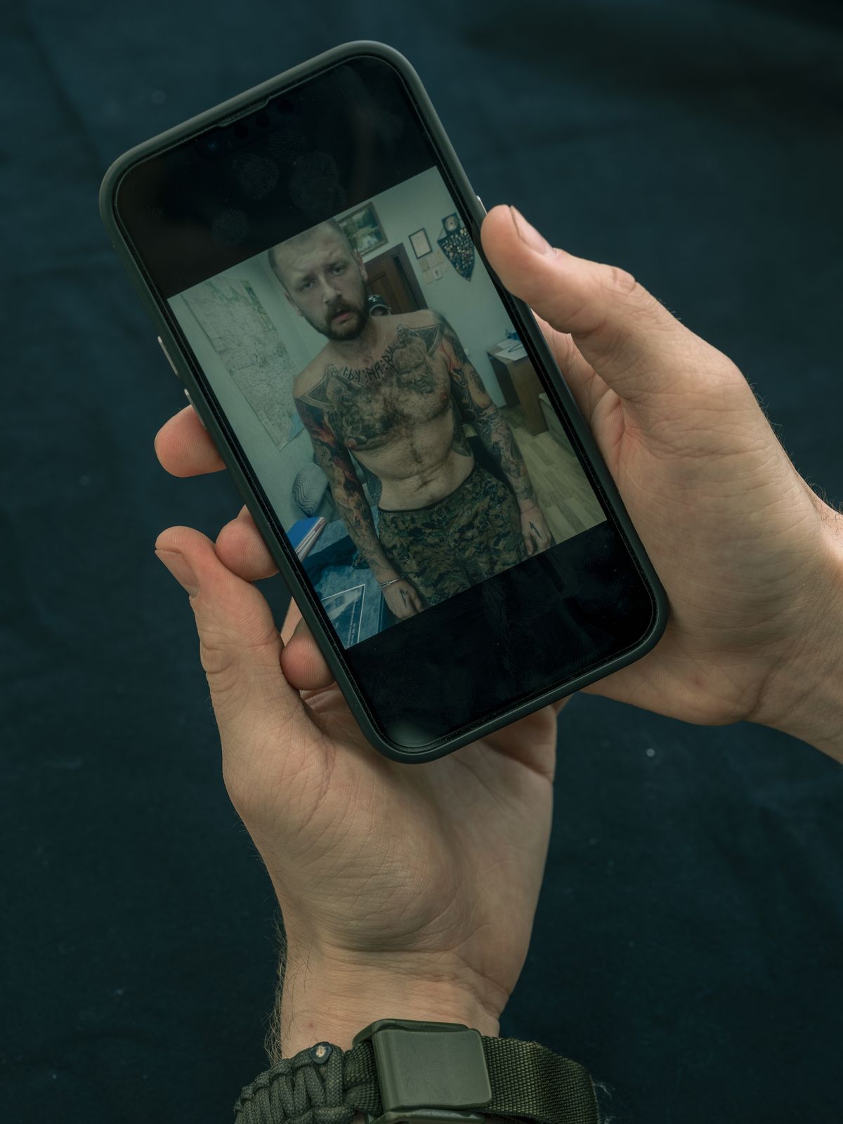 Danilo Mudrak showing a photo of his uncle, Oleh Mudrak, while in Russian captivity, in Kyiv, Ukraine on May 25, 2023. Oleh, the commander of the First Azov Battalion, was unrecognizable and painfully thin when he returned after four months in captivity. He died five months after his release.    (Daniel Berehulak/The New York Times)