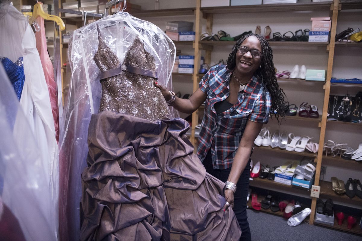 Karen Herford, who has taken over Julianne’s Prom Closet, a nonprofit that loans prom dresses to girls who can’t afford them, shows one of the dress selections Monday, April 17, 2017. The nonprofit is open by appointment only but Herford is hoping to spread the word at local high schools about the service. (Jesse Tinsley / The Spokesman-Review)