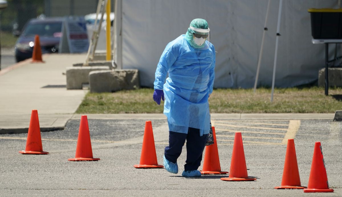 Medical personnel prepare a drive-thru COVID-19 testing site, Friday, Aug. 14, 2020, in San Antonio. Coronavirus testing in Texas has dropped significantly, mirroring nationwide trends, just as schools reopen and football teams charge ahead with plans to play.  (Eric Gay)