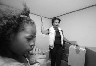 
Regenia Scott and her daughter Tonjea Womack, 9, pack boxes after they were told by FEMA  on Sunday to move from their mobile home in Hammond, La. 
 (Associated Press / The Spokesman-Review)