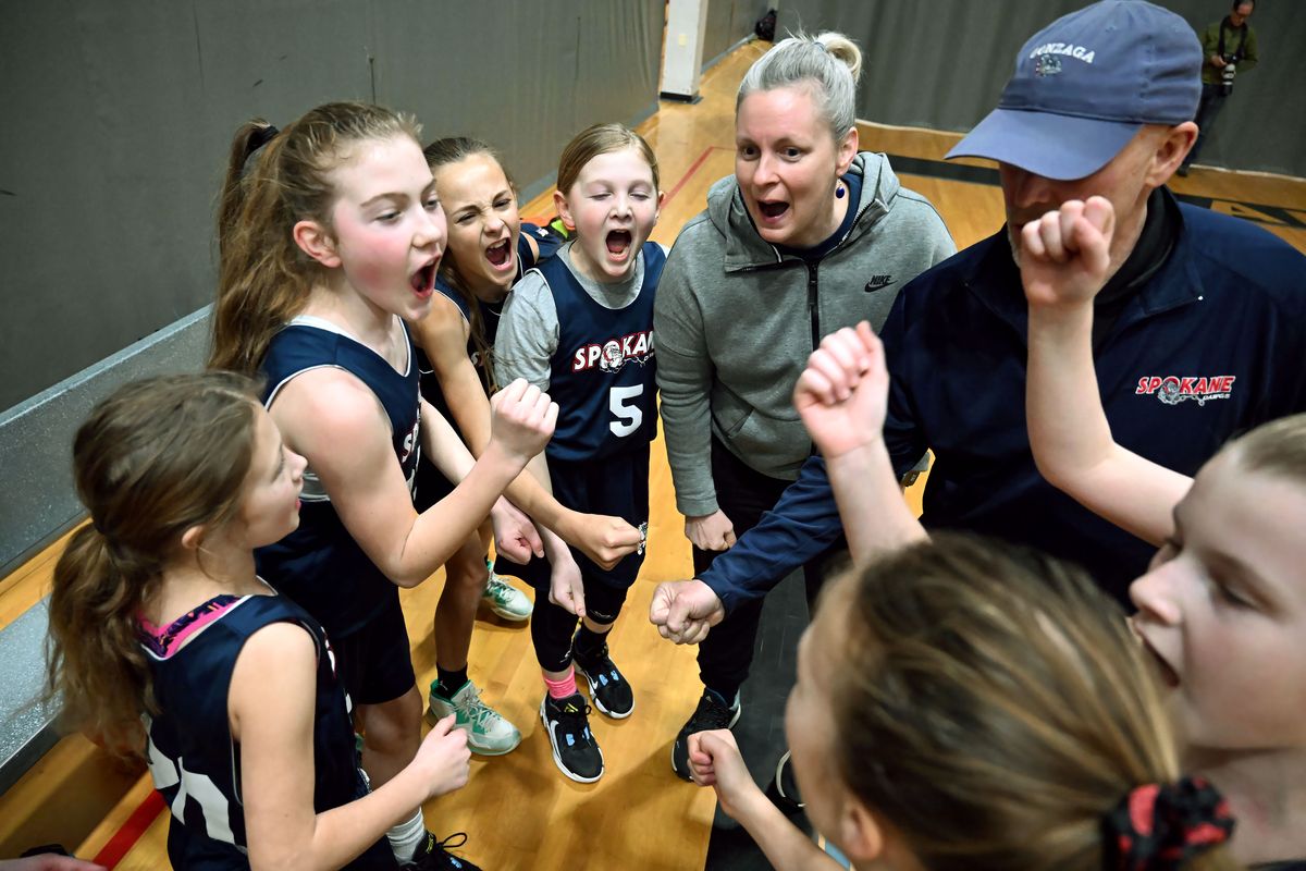 Jen Kerns coaches the fifth-grade Spokane Dawgs club basketball team during a game at HUB Sports Center last month. Kerns switched to a daytime job with the Spokane Police Department so she could coach youth basketball.  (COLIN MULVANY/THE SPOKESMAN-REVIEW)
