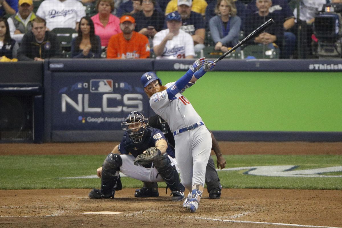 Los Angeles Dodgers’ Justin Turner  hits a two-run home run during the eighth inning of Game 2 of the National League Championship Series against the Milwaukee Brewers on Saturday in Milwaukee. (Charlie Riedel / Associated Press)
