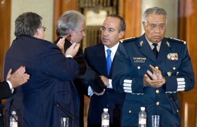 Businessman Alejandro Marti, second left, whose 14-year-old son Fernando Marti was kidnapped and killed in June, shakes hands with Mexico’s President Felipe Calderon at a meeting Thursday. Associate Press (Associate Press / The Spokesman-Review)