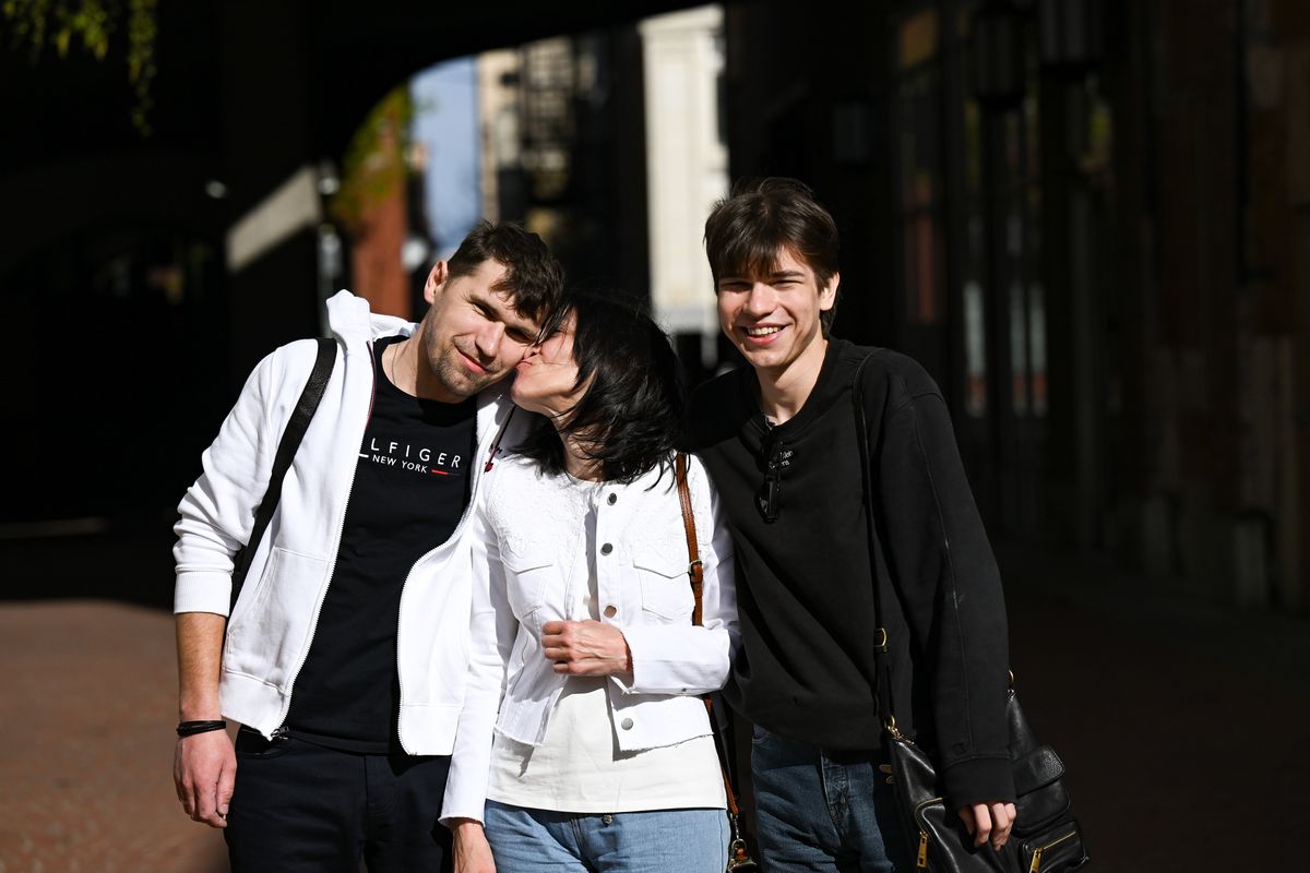 Viktoriia Shamota kisses her husband, Mykola Shamota, as they pose with their son Tymofii Shamota on Wednesday in Spokane. The family are refugees from Ukraine and hoping to stay in the country amid President Donald Trump’s immigration reforms. (Tyler Tjomsland/The Spokesman-Review)