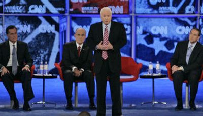 
Sen. John McCain, R-Ariz., stands to answer a question from a woman whose brother had died in Iraq at the Republican presidential primary debate Tuesday  in Manchester, N.H.
 (Associated Press / The Spokesman-Review)