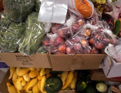 
Boxes and boxes of fresh fruit and vegetables donated through Plant a Row sits in the Valley Food Bank, bagged and ready for distribution. 
 (File/ / The Spokesman-Review)