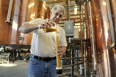 Graydon Brown, brewmaster for the Golden Hills Brewing Co. in Airway Heights, tests the level of fermentation on a batch of Clem’s Gold.colinm@spokesman.com (Colin Mulvany / The Spokesman-Review)