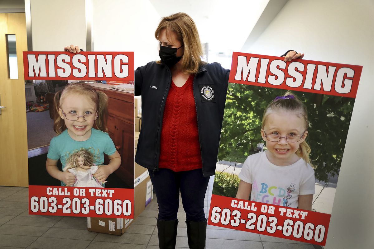 Manchester Police Public Information Officer Heather Hamel holds two reward posters, Tuesday, Jan. 4, 2022, in Manchester, N.H., that show missing girl Harmony Montgomery. The father of the young girl, Adam Montgomery, 31, of Manchester, has been arrested on second-degree assault, custody and child endangerment charges regarding his daughter, but the search for her continues, authorities said Wednesday, Jan. 5.  (John Tlumacki)