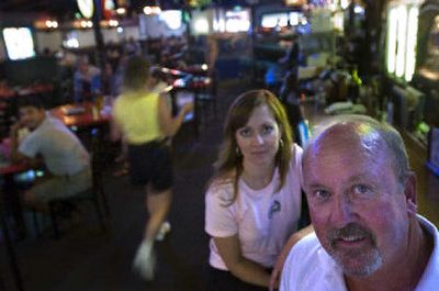 
Bob Materne, owner of The Swinging Doors, and his daughter and general manager, Lisa Ruggles, sit at the bar on Wednesday. 
 (Jed Conklin / The Spokesman-Review)