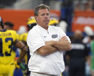 This Sept. 2, 2017, file photo shows then-Florida head coach Jim McElwain watching his team warm up before an NCAA college football game against Michigan, in Arlington, Texas. McElwain was hired by the Wolverines to coach their wide receivers. (Tony Gutierrez / Associated Press)