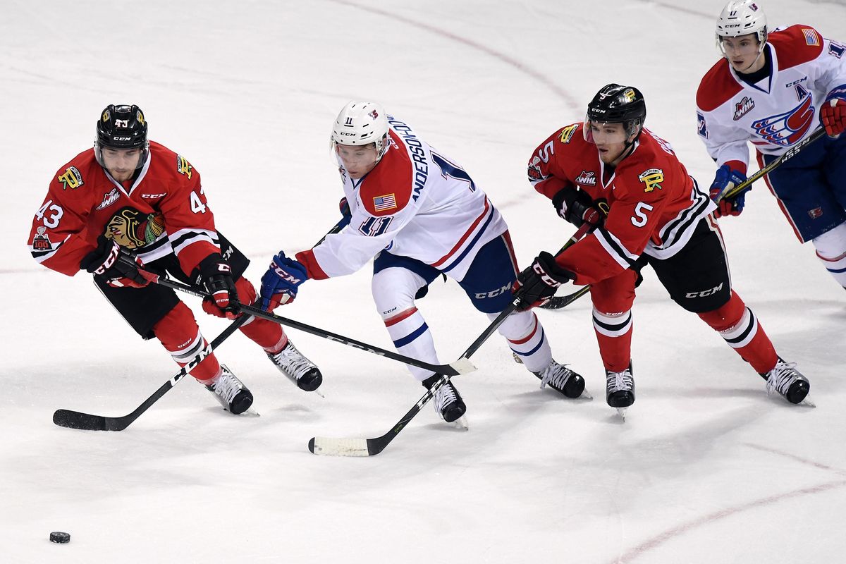 Portland Winterhawks left wing Skyler McKenzie (43), Spokane Chiefs center Jaret Anderson-Dolan (11) and Portland  defenseman Matthew Quigley (5) compete for the puck during a Western Hockey League playoff game  March 28 in the Spokane. (Colin Mulvany / The Spokesman-Review)