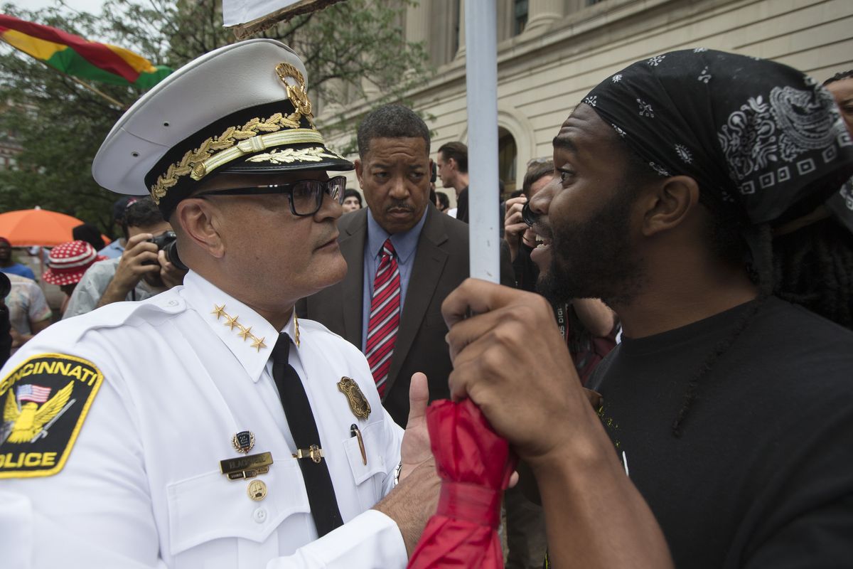 Cincinnati Police Chief Jeffrey Blackwell speaks with a protester during a demonstration outside the Hamilton County Courthouse after murder and manslaughter charges against University of Cincinnati police officer Ray Tensing were announced for the shooting death of motorist Samuel DuBose. (Associated Press)