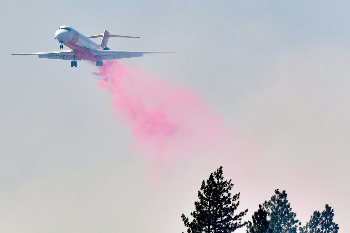 A firefighting jet dumps fire retardant on the Williams Lake fire on Thursday near Cheney.  (Tyler Tjomsland/The Spokesman-Review)