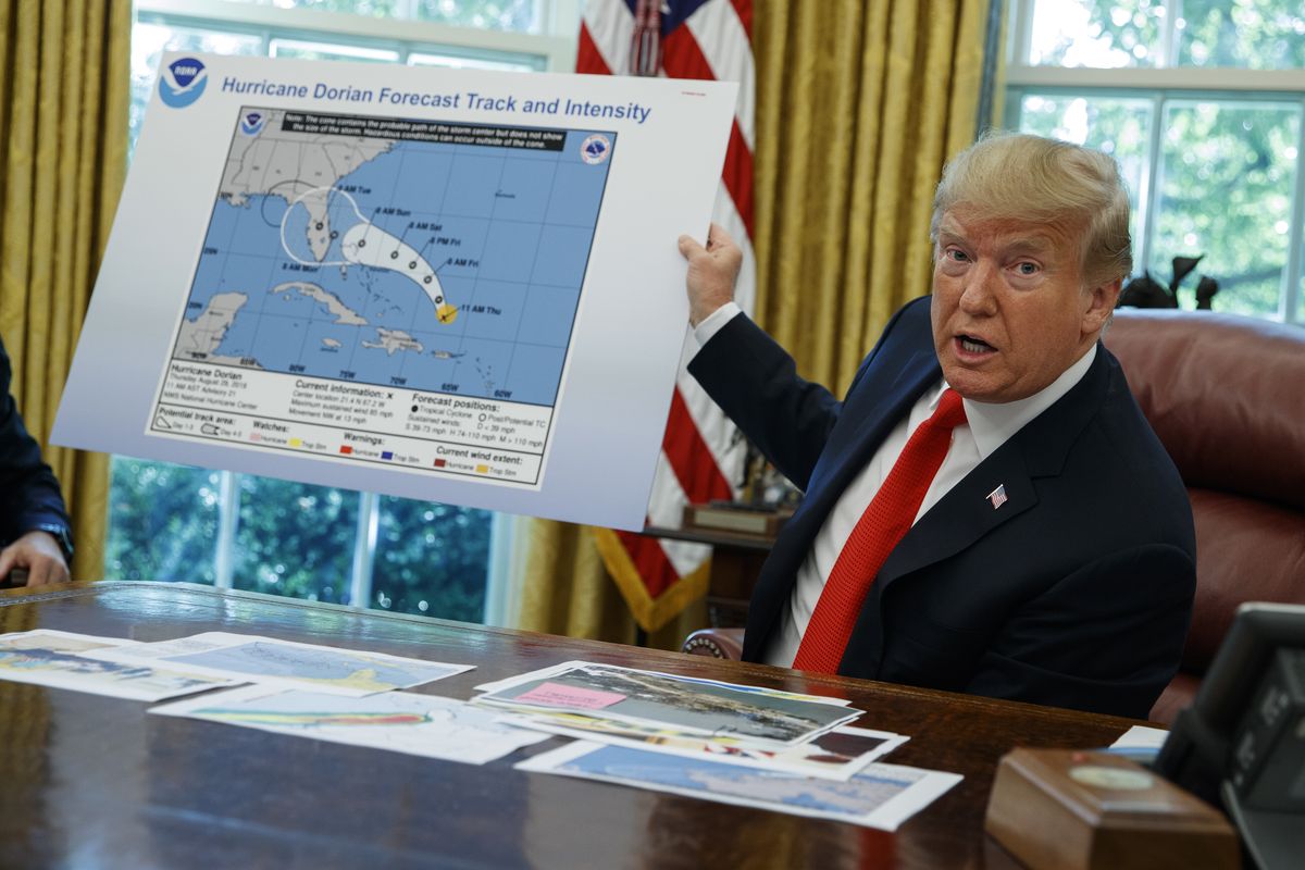 FILE - In this Wednesday, Sept. 4, 2019, file photo, President Donald Trump talks with reporters after receiving a briefing on Hurricane Dorian in the Oval Office of the White House, in Washington. A new 46-person federal scientific integrity task force with members from dozens of government agencies will meet for the first time Friday, May 14, 2021. During Sharpiegate, NOAA reprimanded some meteorologists for tweeting that Alabama was not threatened by the hurricane, contradicting the president, who said Alabama was in danger.  (Evan Vucci)