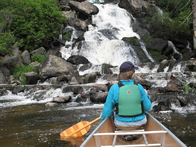 Canoeists enjoy the waterfalls on the West Branch of the Little Spokane River. The 50-foot Exley Falls, which tumble into Horseshoe Lake in Pend Oreille County just north of Eloika Lake, run strong in spring but ease back a trickle in summer. (Rich Landers)