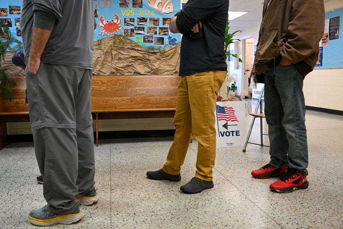 Voters wait in line at a polling station Oct. 29 in Grand Rapids, Mich.  (Joshua Lott/The Washington Post)