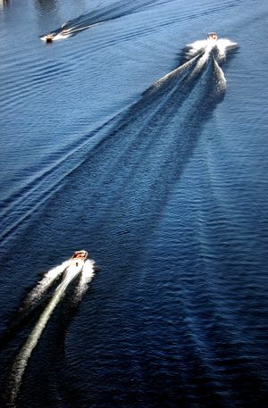 Boats make patterns with their wakes on the Spokane River in Post Falls, Idaho, as seen from a helicopter.   (The Spokesman-Review)