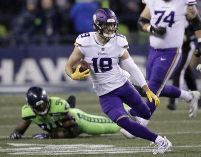 In this Dec. 10, 2018,  photo, Minnesota Vikings’ Adam Thielen runs with the ball after a reception against the Seattle Seahawks in the second half of an NFL football game in Seattle. The Vikings and wide receiver Thielen have agreed in principle to a four-year contract extension valued at $64 million. The Vikings announced the deal Friday, April 12, 2019. (Stephen Brashear / Associated Press)