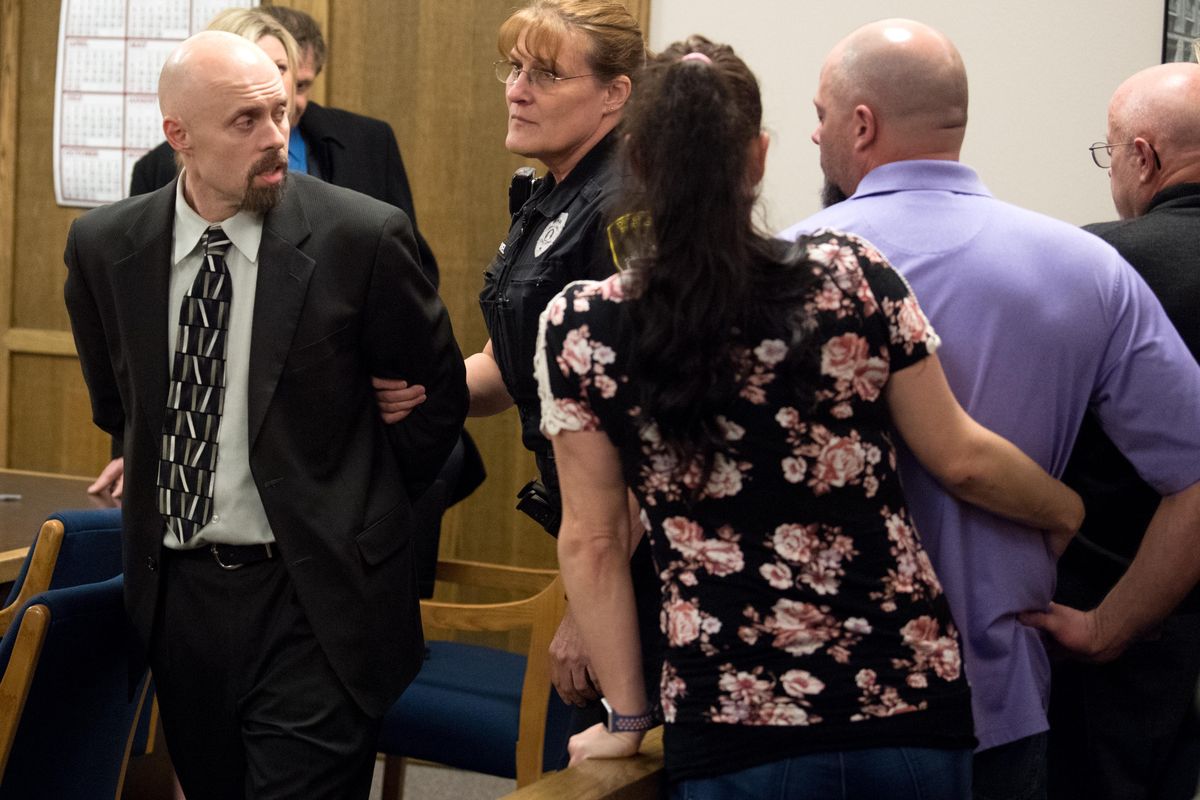 Former Spokane police Sgt. Gordon Ennis says goodbye to his family as he is handcuffed after a jury found him guilty of sexually assaulting another police officer on Wednesday, March 7, 2018, Spokane County Superior Court in Spokane, Wash. (Tyler Tjomsland / The Spokesman-Review)