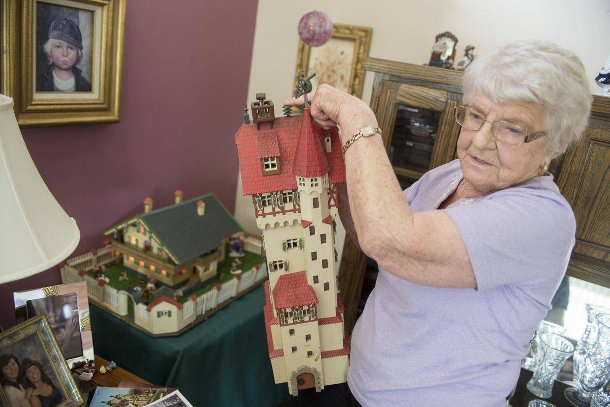Waltraud Gardner shows the details on the model wooden tower and classic German house her father made many years ago Monday at her home in Spokane Valley. The house and water tower are icons of her childhood home, Grafenwoehr, a town in Germany which is now dominated by an American military base. As a child, she walked by the house and tower almost every day. (Jesse Tinsley / The Spokesman-Review)