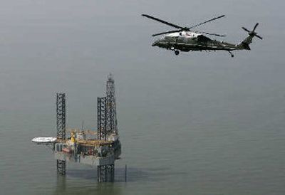 
President Bush, on board Marine One, gets an aerial tour Tuesday, of an off-shore oil rig off the coast of Louisiana damaged by Hurricane Rita. 
 (Associated Press / The Spokesman-Review)