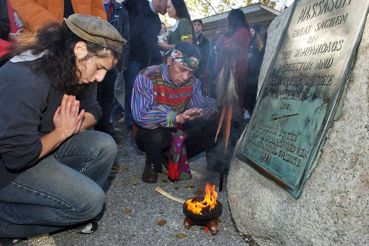 Supporters of Native Americans pause following a prayer in 2007 during the 38th National Day of Mourning at Coles Hill in Plymouth, Mass.  (Lisa Poole)