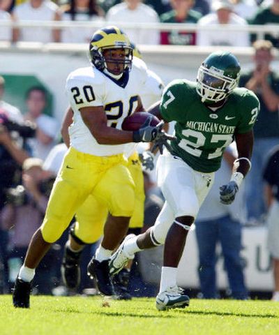 
Michigan State defensive back SirDarean Adams, right, closes in on Michigan running back Mike Hart during first-quarter action in Saturday's Big Ten Conference game at Spartan Stadium in East Lansing, Mich. 
 (Associated Press / The Spokesman-Review)