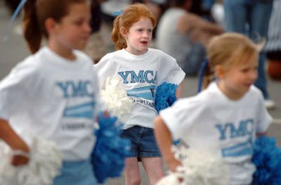 
Grace Hardesty, 5, center, concentrates on the routine as the YMCA cheerleaders perform Saturday at Valley Hooops in Spokane Valley. More than 170 teams turned out to help raise money for YMCA scholarships. 
 (Joe Barrentine / The Spokesman-Review)