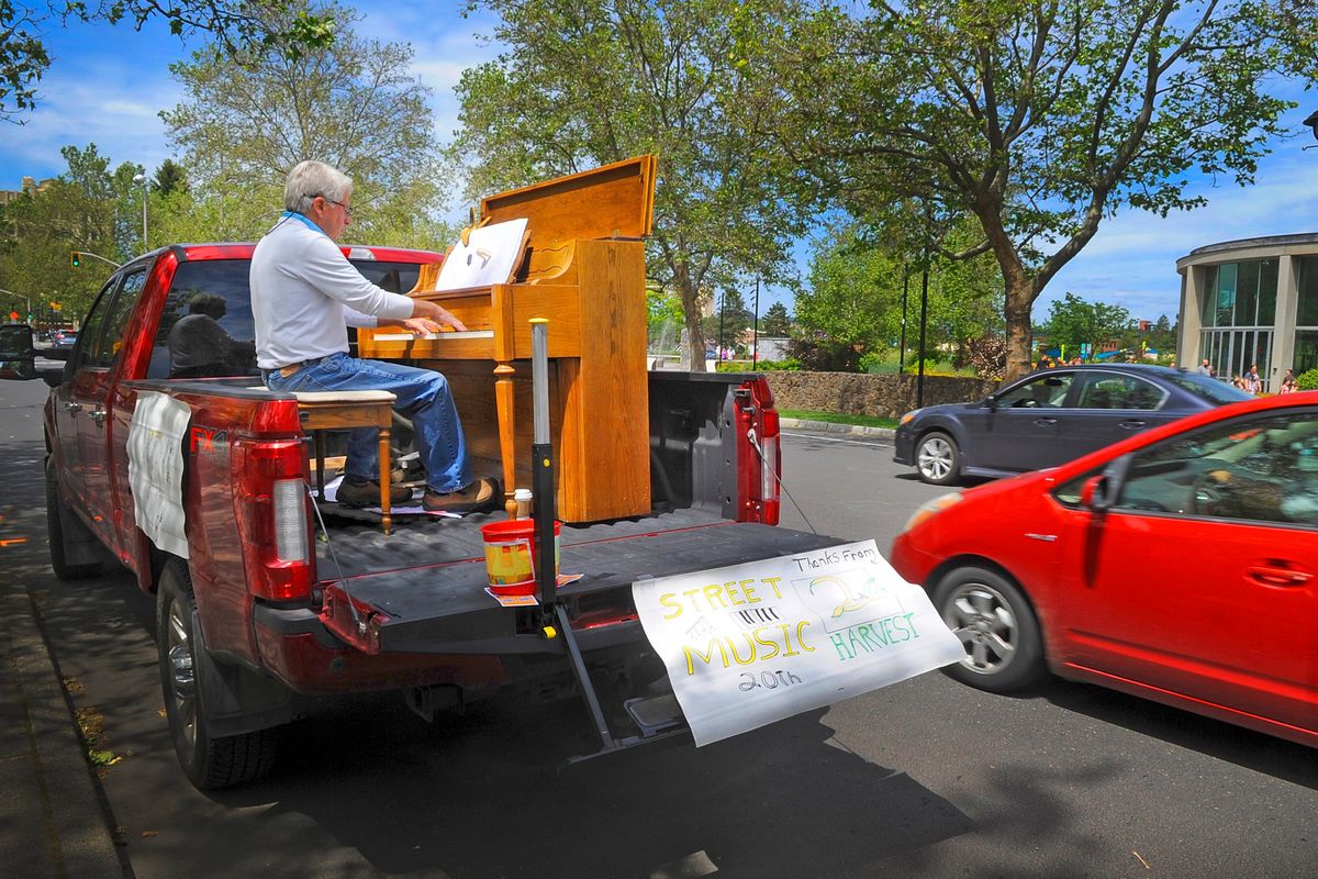 Gary Cantlon pounds the keyboard from the back of his pickup parked across from Riverfront Park in downtown Spokane, Wednesday, June 15, 2022, during the annual Street Music fundraiser. The retired Spokane doctor entertained with hits from Hotel California to Phantom of the Opera.   (Christopher Anderson For The Spokesman-Review)