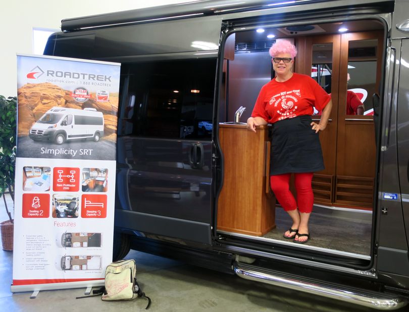 Leslie Kelly checks out the Roadtrek Simplicity at RnR RV Center in Spokane Valley. (John Nelson)