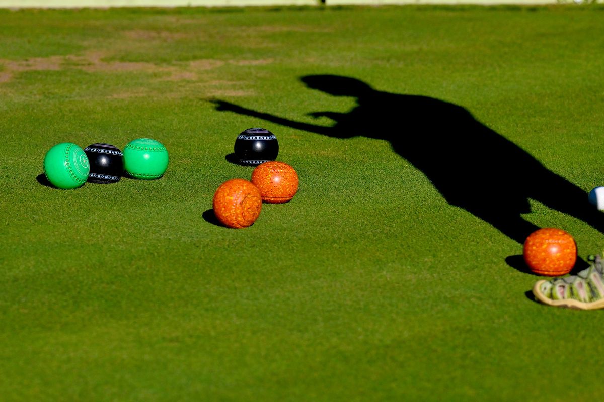 Tim Quirk talks about the placement of the bowls during a lawn bowling match at Mission Park in Spokane on Tuesday, August 1, 2023.  (Kathy Plonka/The Spokesman-Review)