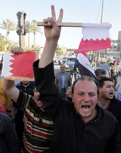 Protesters chant anti-Saudi government slogans and wave Bahraini and Iraqi flags during a demonstration in Baghdad on Thursday. (Associated Press)
