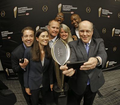 Executive director Bill Hancock, right, is more open to moving College Football Playoff semifinals dates after TV ratings plummeted last season. (Paul Moseley / Associated Press)
