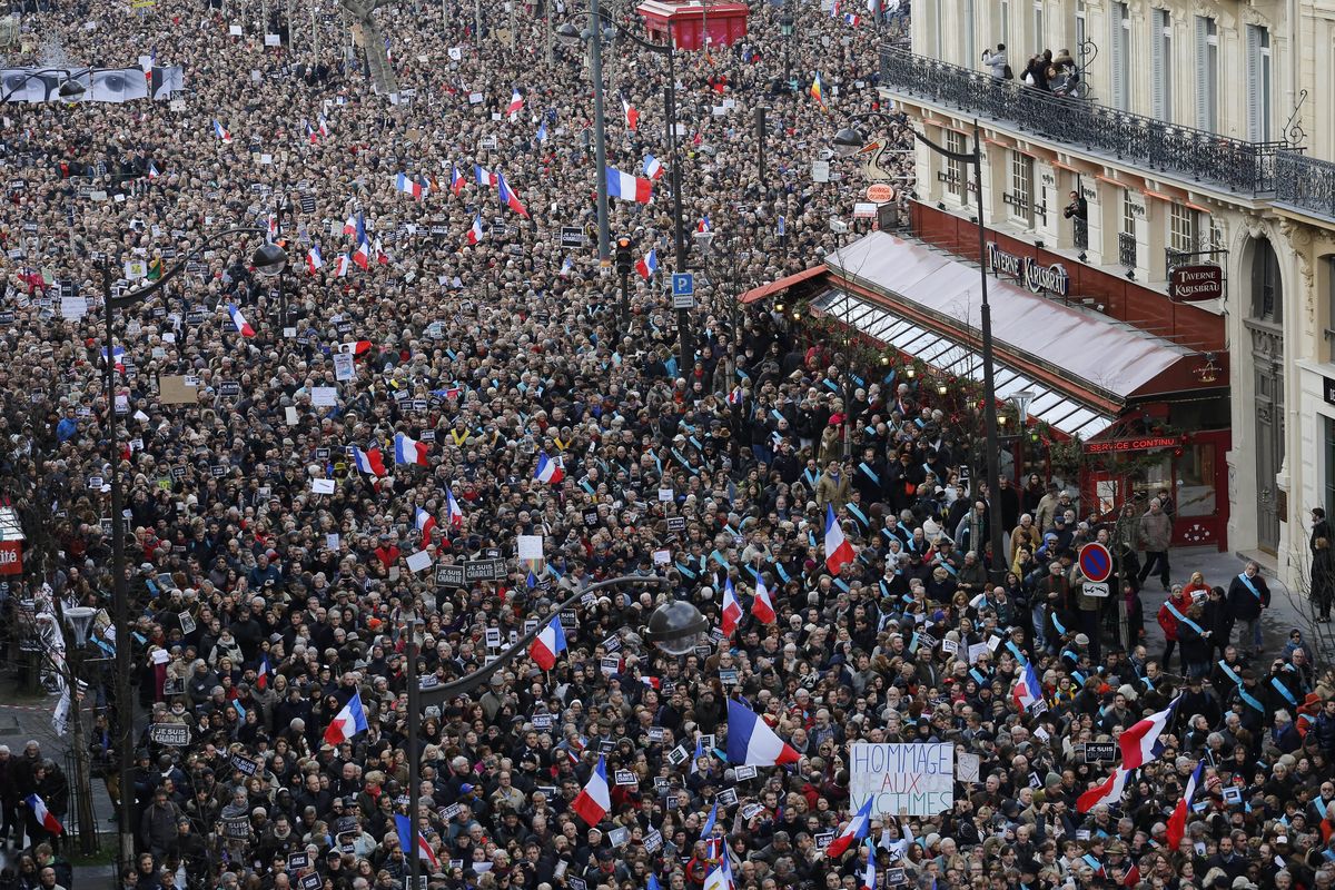 Hundreds of thousands of people march through Paris on Sunday in a massive show of unity and defiance in the face of terrorism that killed 17 people. (Associated Press)