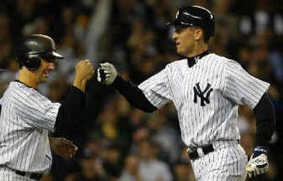 
Jorge Posada, left, congratulates John Olerud after his two-run homer in the sixth. 
 (Associated Press / The Spokesman-Review)