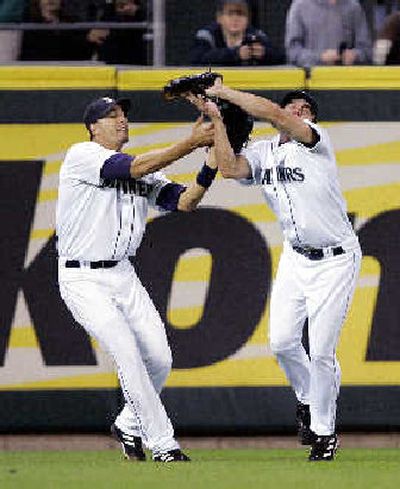 
Seattle center fielder Jaime Bubela, right, catches a fly ball Thursday with left fielder Mike Morse moving in. 
 (Associated Press / The Spokesman-Review)