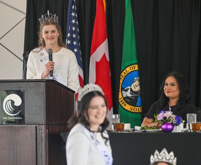 Lilac Festival Queen Madeleine Froese, upper left, introduces her court to the crowd at a luncheon Friday at the Centennial Hotel. Froese and her court will participate in the Lilac Festival’s annual Armed Forces Torchlight Parade Saturday. At right is KHQ-TV weathercaster Jenny Powers.  (Jesse Tinsley/The Spokesman-Review)