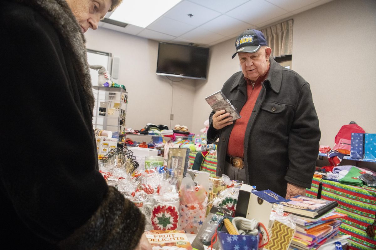 Navy veteran Ed Schiffner, right, and his wife, Eleanor,  look over the modest gift shop set up by  American Legion Auxiliary volunteers Thursday, Nov. 29, 2018, at the Mann-Grandstaff VA Medical Center. (Jesse Tinsley / The Spokesman-Review)