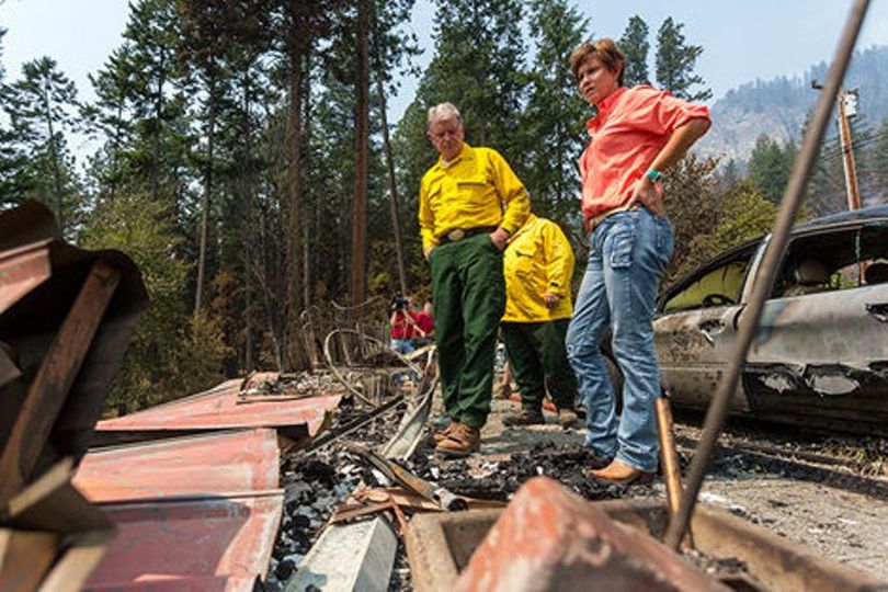 Idaho Governor Butch Otter, left and wife Laurie, look over the wreckage of a home that was destroyed by the Cape Horn Fire. Otter visited the fire and the crews on Thursday morning. Story below. (Matt Weigand / Coeur d'Alene Press)