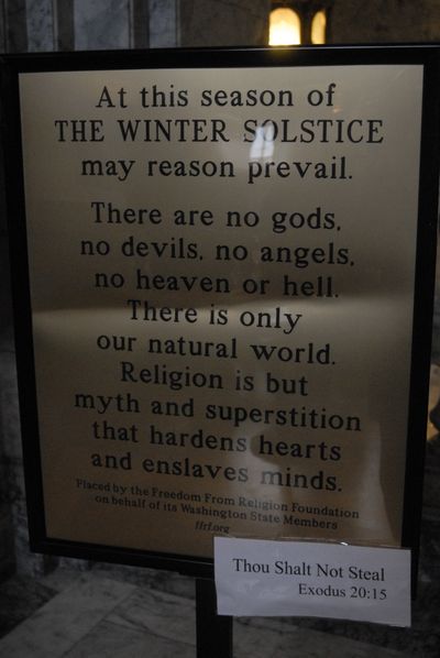 This winter solstice sign erected at Washington's state capitol by an atheist group from Wisconsin was briefly stolen. After state police recovered it, someone attached a 