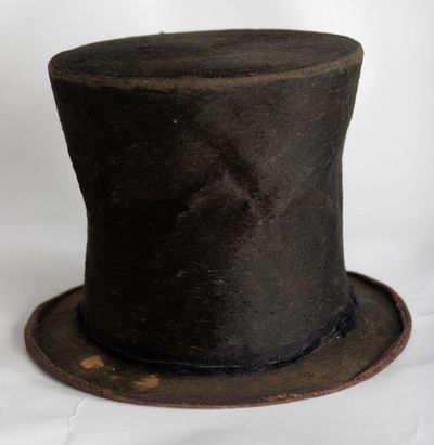 FILE - In this June 14, 2007 file photo, Abraham Lincoln's iconic stovepipe hat is photographed at the Abraham Lincoln Presidential Library and Museum in Springfield, Ill. The foundation that supports the library and museum says it might have to sell artifacts if it can't pay off a decade-old loan that financed items related to the 16th president. the foundation says it owes $10 million on a 2007 loan it obtained for the well-known Barry and Louise Taper Collection of Lincoln-related items including a stovepipe hat and bloodstained gloves. (AP Photo/Seth Perlman File) ORG XMIT: CER201 (Seth Perlman / AP)